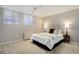 Bedroom featuring neutral decor, plush carpet, and two windows for natural light at 909 N Logan St # 1B, Denver, CO 80203