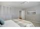 Neutral bedroom featuring carpet, a plaid blanket, white walls, and ample closet space at 909 N Logan St # 1B, Denver, CO 80203