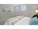 A sun-filled bedroom with carpet, light gray walls, two windows, and neutral decor at 909 N Logan St # 1B, Denver, CO 80203