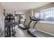 Home gym featuring an elliptical, treadmills, free weights, and a wall-mounted television for entertainment at 909 N Logan St # 1B, Denver, CO 80203