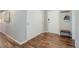 Hallway with wood floors, white doors, coat rack, and bench at 909 N Logan St # 1B, Denver, CO 80203