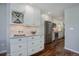 Modern kitchen with white cabinets, stainless steel appliances, and wood floors at 909 N Logan St # 1B, Denver, CO 80203