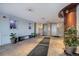 Inviting lobby area with tile floors, seating, art display, and elevator access at 909 N Logan St # 1B, Denver, CO 80203