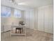 The home office has neutral carpet, white walls, two windows, and multiple closets at 909 N Logan St # 1B, Denver, CO 80203