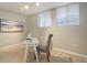 Home office featuring two windows, gray carpet, neutral paint, and track lighting at 909 N Logan St # 1B, Denver, CO 80203