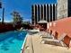 Outdoor pool area with clear blue water, plenty of lounge chairs, and partial shade at 909 N Logan St # 1B, Denver, CO 80203