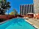 Outdoor swimming pool with lounge chairs, surrounded by a wall and a gazebo at 909 N Logan St # 1B, Denver, CO 80203