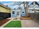 Charming backyard with artificial turf, patio, and brick pathway, perfect for outdoor enjoyment at 161 W Maple Ave, Denver, CO 80223