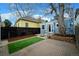 Charming backyard with artificial turf, patio, and brick pathway, perfect for outdoor enjoyment at 161 W Maple Ave, Denver, CO 80223