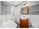 Charming bathroom with clawfoot tub, vanity, and wainscoting, creating a cozy and functional space at 161 W Maple Ave, Denver, CO 80223