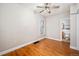 Bright bedroom with hardwood floors and access to a bathroom, offering a comfortable and convenient living space at 161 W Maple Ave, Denver, CO 80223