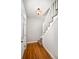 Bright entryway featuring hardwood floors and staircase with carpet runner at 161 W Maple Ave, Denver, CO 80223