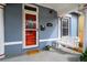 Charming front porch featuring a classic porch swing, red door, and inviting curb appeal at 161 W Maple Ave, Denver, CO 80223
