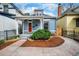 Charming home with well-maintained landscaping, red door, stone pathway, and inviting curb appeal at 161 W Maple Ave, Denver, CO 80223