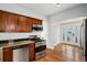 Updated kitchen with stainless appliances, granite counters, and hardwood floors at 161 W Maple Ave, Denver, CO 80223
