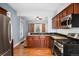 Renovated kitchen featuring granite counters, stainless appliances, and exposed brick at 161 W Maple Ave, Denver, CO 80223