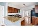 Updated kitchen with granite counters, stainless appliances, and dark wood cabinets at 161 W Maple Ave, Denver, CO 80223