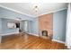 Spacious living room with hardwood floors and a brick fireplace at 161 W Maple Ave, Denver, CO 80223
