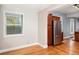 Living room with stainless refrigerator, hardwood floors and window at 161 W Maple Ave, Denver, CO 80223