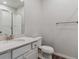 Clean bathroom with white vanity, large mirror, and neutral tile flooring at 3494 N Irvington St, Aurora, CO 80019
