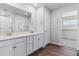 Bright bathroom boasts double sinks, a walk-in shower, and access to a large closet at 3494 N Irvington St, Aurora, CO 80019