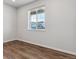 Spacious bedroom with hardwood floors and large window offering natural light at 3494 N Irvington St, Aurora, CO 80019