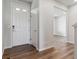 Bright entryway with white door, hardwood floors, and view into living area at 3494 N Irvington St, Aurora, CO 80019