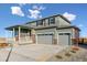 Two-story house with gray siding, brick accents, and a three-car garage at 3494 N Irvington St, Aurora, CO 80019