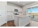 Open kitchen features island, stainless steel appliances, and access to backyard at 3494 N Irvington St, Aurora, CO 80019
