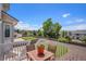 The fenced backyard features a cozy patio area with a table and chairs, perfect for outdoor relaxation at 1325 Kingsfield St, Castle Rock, CO 80104