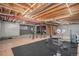 Spacious basement with a workout area, exposed beams, and plenty of room for storage at 1325 Kingsfield St, Castle Rock, CO 80104