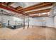 Large basement with high ceilings and natural light, featuring wood beams and ready for finishing touches at 1325 Kingsfield St, Castle Rock, CO 80104