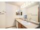 Bathroom features a single sink vanity with a large mirror and ample lighting at 1325 Kingsfield St, Castle Rock, CO 80104