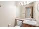 Powder room with single sink vanity and a large mirror at 1325 Kingsfield St, Castle Rock, CO 80104