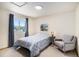 Bright bedroom features a window with blue curtains, a chair, and star decor at 1325 Kingsfield St, Castle Rock, CO 80104