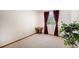 Bedroom with neutral carpet features a window with red curtains and a plant at 1325 Kingsfield St, Castle Rock, CO 80104