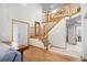 Spacious foyer featuring a wood staircase, hardwood floors, a white front door, and an open layout at 1325 Kingsfield St, Castle Rock, CO 80104