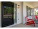 Inviting front porch with stylish seating, a charming address plaque, and freshly painted white siding at 1325 Kingsfield St, Castle Rock, CO 80104