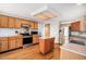 Spacious kitchen with hardwood floors, stainless steel appliances, and center island at 1325 Kingsfield St, Castle Rock, CO 80104