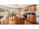 Bright kitchen featuring hardwood floors, modern appliances, and a convenient center island at 1325 Kingsfield St, Castle Rock, CO 80104