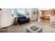 Comfortable living room featuring a large window with views, a cozy sofa and access to the kitchen at 1325 Kingsfield St, Castle Rock, CO 80104