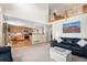 Open-concept living room flows into a kitchen, featuring a hardwood floor, with comfortable seating, and an open design at 1325 Kingsfield St, Castle Rock, CO 80104