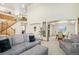 Bright living room featuring a plush sofa, arched doorway, and dining area with ample natural light at 1325 Kingsfield St, Castle Rock, CO 80104