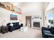 Comfortable living room featuring a fireplace, built-in shelving, and an open floor plan at 1325 Kingsfield St, Castle Rock, CO 80104