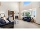 Cozy living room with a decorative fireplace, built-in shelves, and large windows with natural lighting at 1325 Kingsfield St, Castle Rock, CO 80104