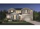 Charming two-story home with a gray exterior, lush landscaping, and a well-maintained front yard at 6289 Cristobal Pt, Parker, CO 80134