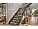 Elegant staircase featuring wood treads, glass railings, and modern design elements at 6289 Cristobal Pt, Parker, CO 80134