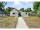 Back exterior of home with siding, small windows, and concrete walkway at 12 Marshall Pl, Longmont, CO 80504