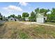 View of the backyard featuring the home, shed, and concrete area at 12 Marshall Pl, Longmont, CO 80504