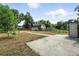 Large backyard with mature trees, shed, and concrete patio at 12 Marshall Pl, Longmont, CO 80504